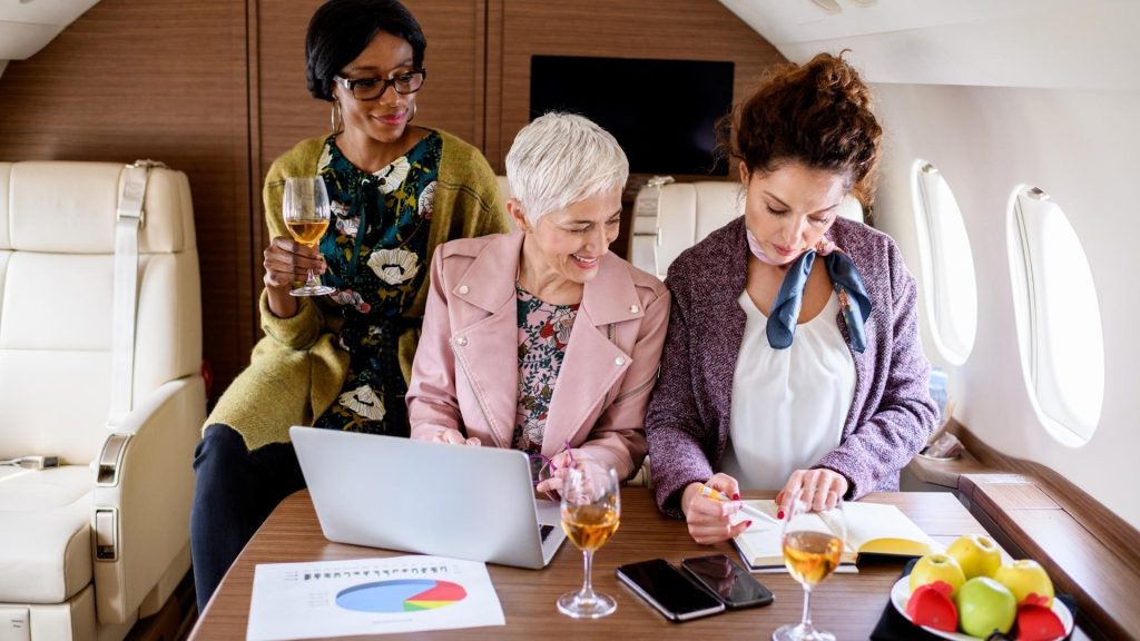 Professionals conducting a meeting inside a corporate jet, demonstrating the productivity benefits of business aviation.